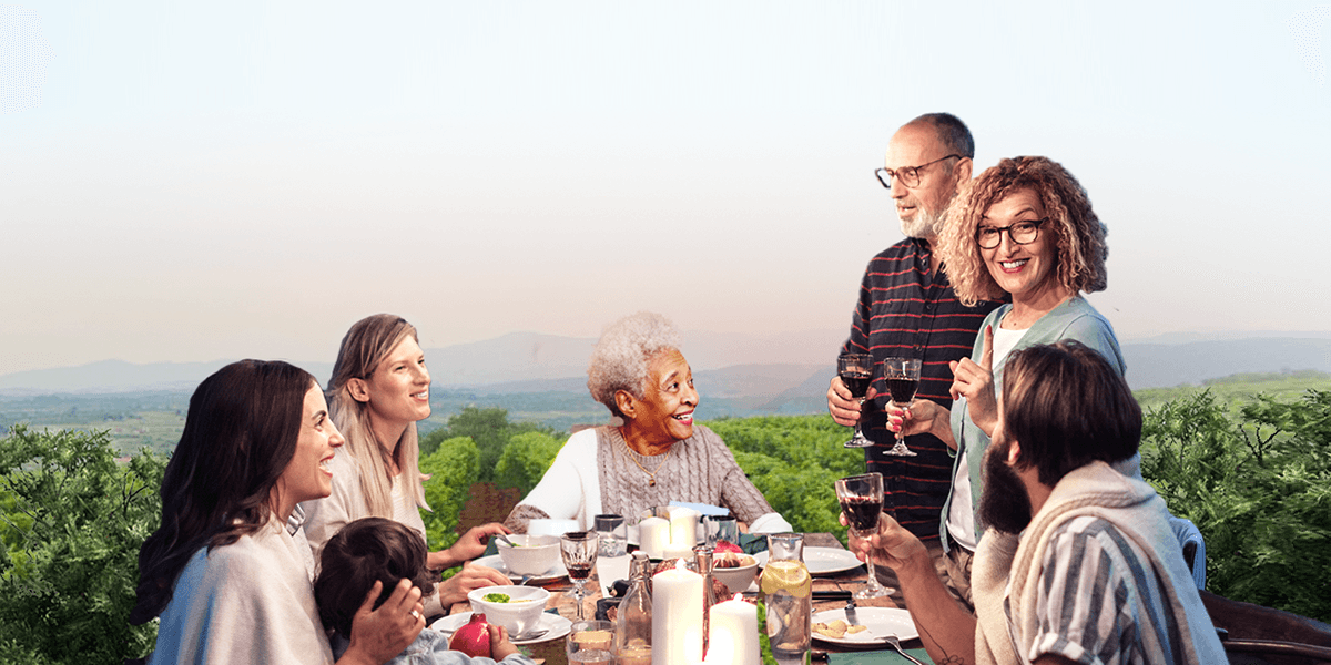 A photo of a retiree couple enjoying their family dinner at a vineyard.